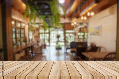 Wooden Table With Blurred Of The Restaurant Background Stock Photo