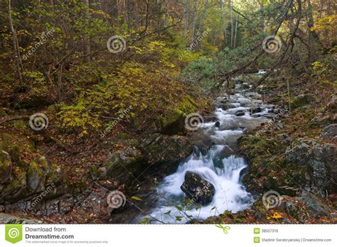 Autumn Landscape With A Waterfall On The Creek Taiga Stock Photo