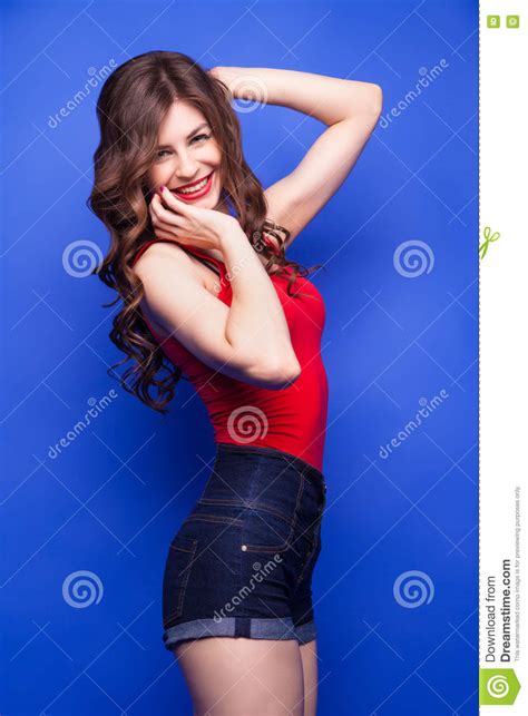 Portrait Of Happy Brunette Model With Red Lips And Wavy Hair Stock Image Image Of Denim