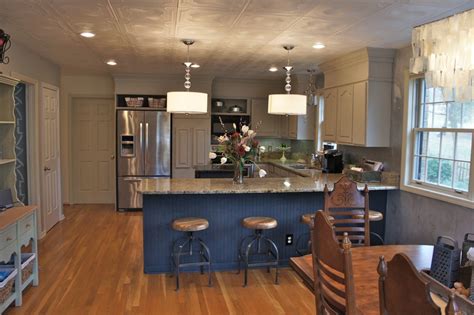 Before starting a kitchen paint job, empty the cabinets, clear off the counters, and remove freestanding appliances. Painting Kitchen Cabinets and brick lighten up a kitchen
