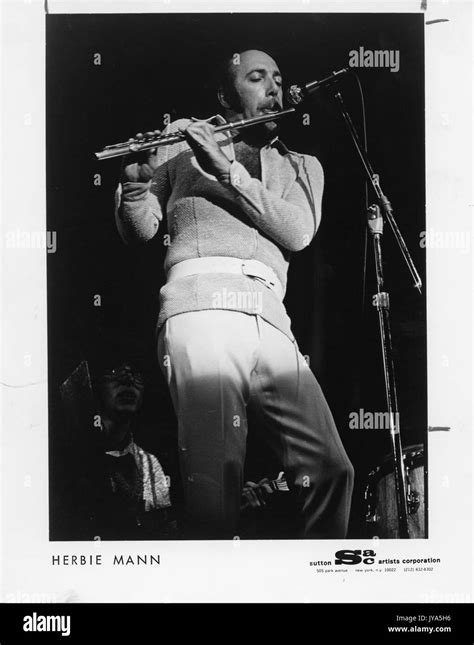 photograph of herbie mann famous american jazz flutist standing on stage underneath a