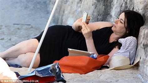 nigella lawson back on the beach in slightly less conservative outfit daily mail online