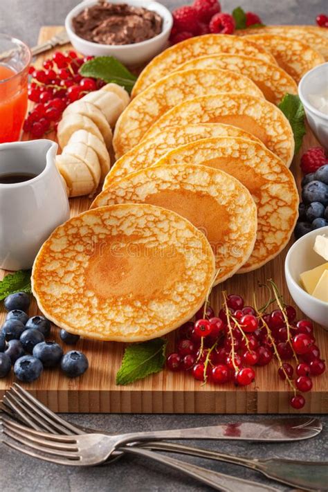 American Pancake Board With Berries Maple Syrup Butter Stock Photo