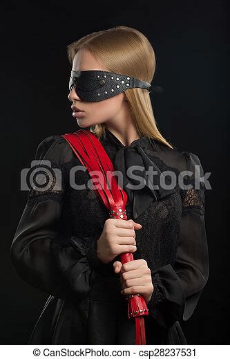 Portrait Of A Girl With Red Leather Whip And Mask Bdsm