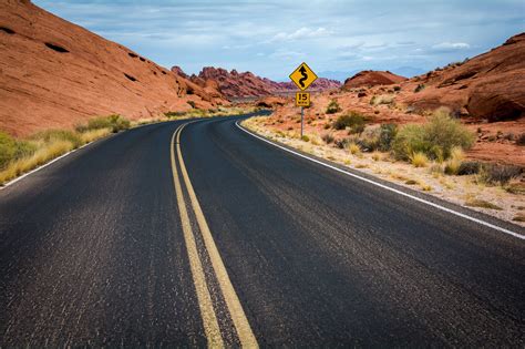 Landscape Photography Of Road Between Desert Hills Hd Wallpaper
