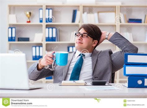 The Businessman Chained With Handcuffs To His Coffee Stock Image