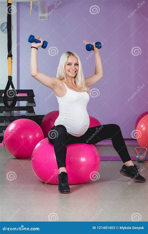 Beauty Sporty Pregnant Woman Working Out In Gym With Balls On The
