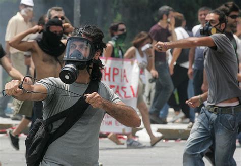 Greek Riot Police Fire Tear Gas At Stone Throwing Protesters In Athens