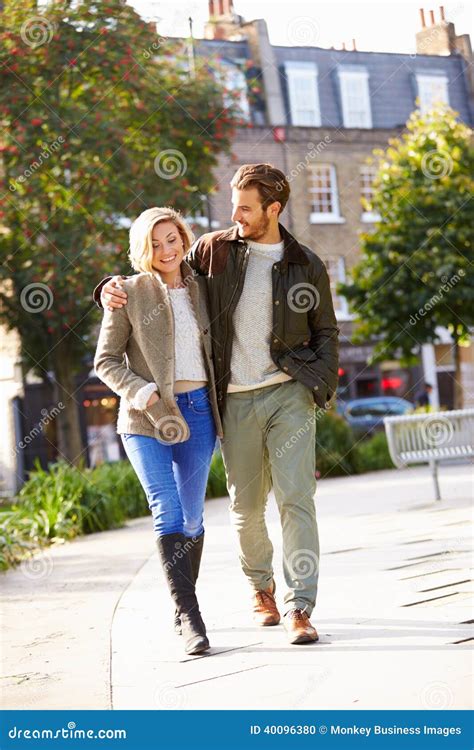 Young Couple Walking Through City Park Together Stock Photo Image Of