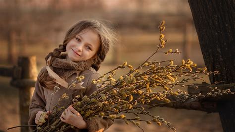 Smiley Cute Little Girl Is Wearing Brown Dress And Holding