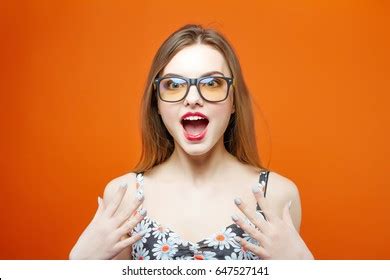 Emotional Screaming Brunette Eyeglasses On Orange Stock Photo