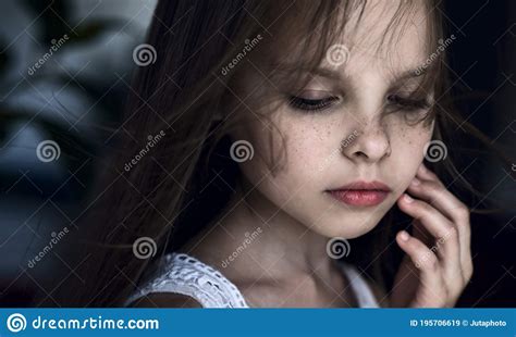 Sad Little Girl With Tears On Pretty Face Is Crying Indoors Stock Image