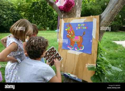 Child And Parent Setting Up Birthday Party Game Pin The Tail On The