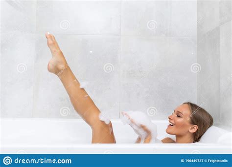 Beautiful Smile Woman Washing Leg In Bath With Foam Young Woman