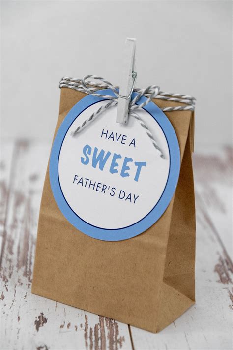 A Brown Paper Bag With A Blue And White Tag That Says Have A Sweet