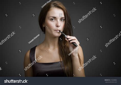 Elegant Beautiful Woman Smoking Ecigarette Stock Photo