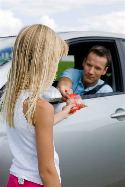 A Male Stranger In A Car Trying To Lure A Girl With Candies Stock Image Colourbox