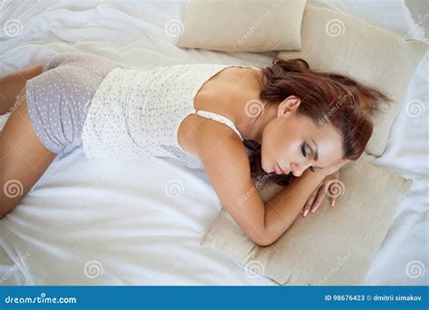 Beautiful Woman In Pajamas Lying On The Bed After Sleeping Stock Image