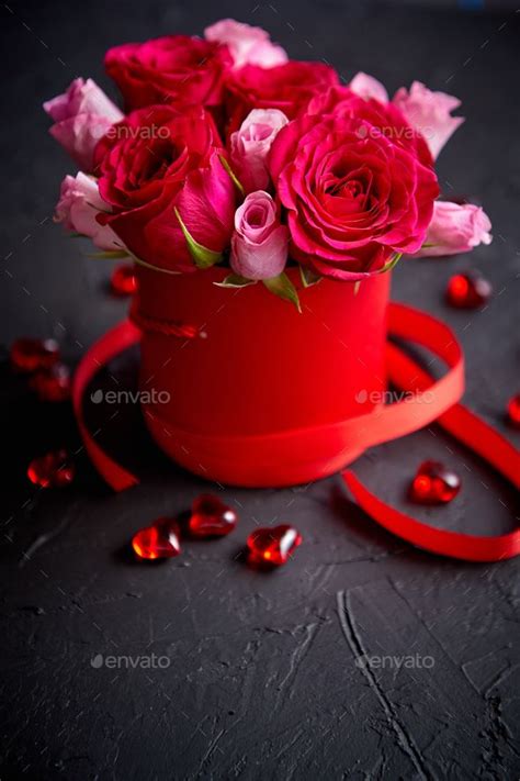 Pink Roses Bouquet Packed In Red Box And Placed On Black Stone