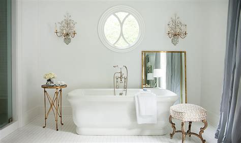 To avoid making this room seem small and claustrophobic, the design here is focused on white (and a lot of it!) with black to accentuate mirrors, windows, and doors. Our Top Decorating Ideas for a White Bathroom