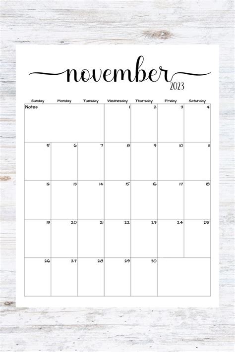 The Printable November Calendar Is Shown On A Wooden Table With White