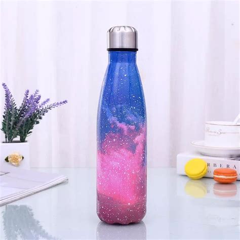 A Blue And Pink Water Bottle Sitting On Top Of A Table Next To A Laptop