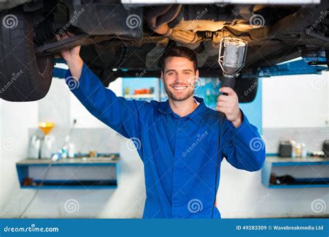 Mechanic Using Torch To Look Under Car Stock Image Image Of Shining