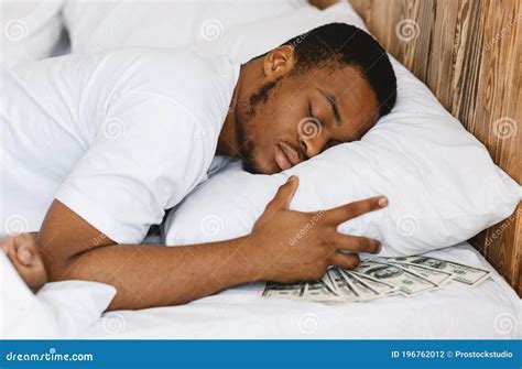 Black Man Sleeping Hiding Money Under Pillow In Bed Indoors Stock Photo Image Of Lying Home