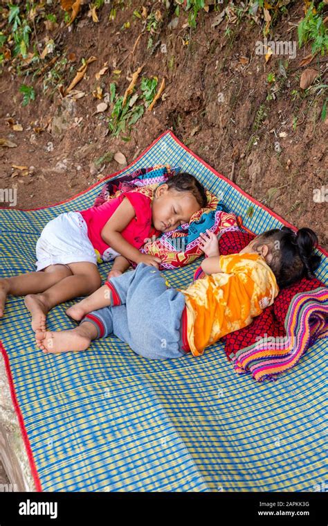 Two Young Girls Nap On A Mat While Their Mothers Sell Ts To Tourists