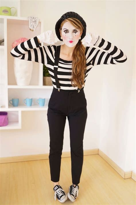 A Woman In Black And White Striped Shirt With Makeup On Her Face Posing