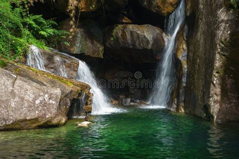 Swimming Towards A Secret Cave Behind An Emerald Waterfall Stock Photo
