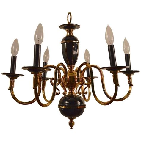 Polished brass fixture with white acrylic globes. Six-Light Candle Style Black and Brass Chandelier For Sale ...