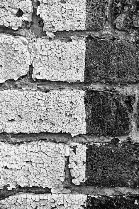 Black And White Photograph Of An Old Brick Wall That Has Been Stripped