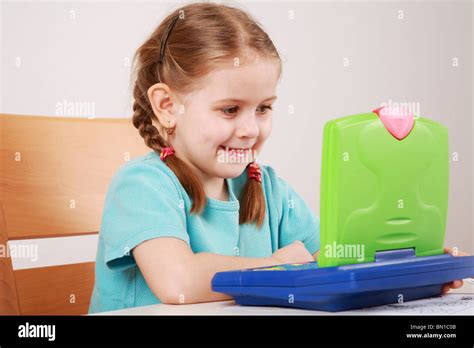 Cute Little Girl Playing With Computer Stock Photo Alamy