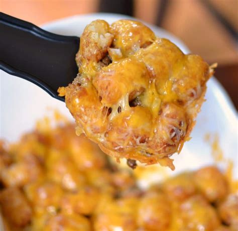 Add 1/2 cup of water, 2/3 cup of enchilada sauce, corn, bell pepper, and beans. Tater Tot Taco Casserole | Small Town Woman