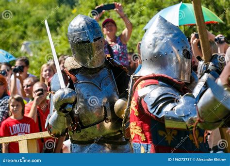 Medieval Restorers Fight With Swords In Armor At A Knightly Tournament