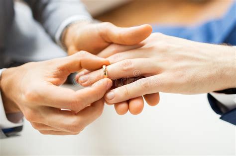 Close Up Of Male Gay Couple Hands And Wedding Ring Stock