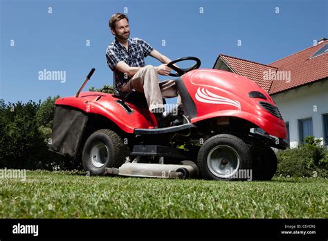 Man Riding Lawn Mower In Backyard Stock Photo Royalty Free Image