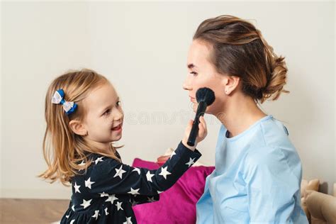 Mother And Daughter Are Doing Makeup Lovely Mom And Child Having Fun