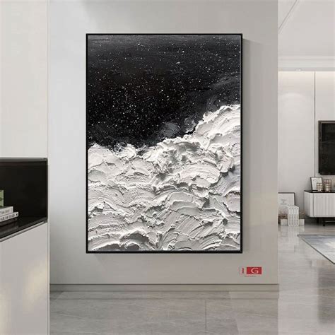An Abstract Painting Hangs On The Wall In A White Room With Black And