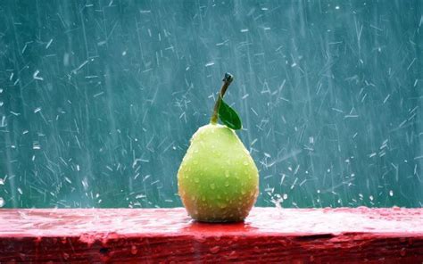 An Apple With The Words Enjoy The Rain Written On It Sitting On A Red Table
