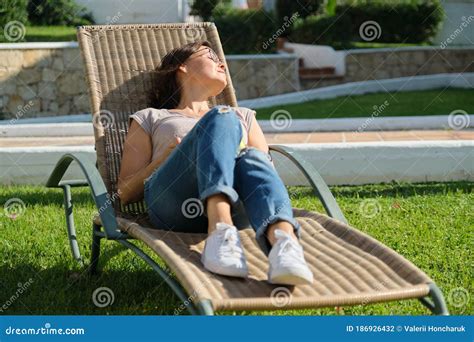 Mature Adult Woman Resting Lying In An Outdoor Chair On The Lawn Stock Photo Image Of Chair