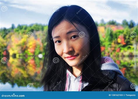 chinese woman looking at the camera with fall foliage background stock image image of morning