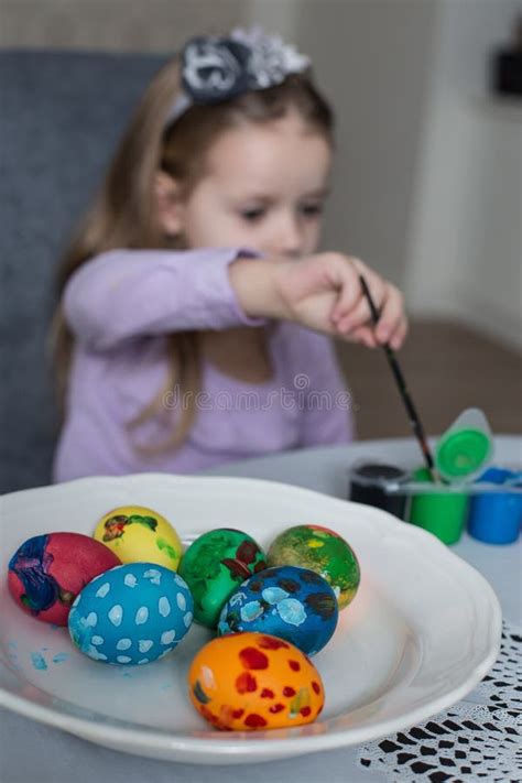 A Cute Little Girl Coloring Easter Eggs Stock Photo Image Of