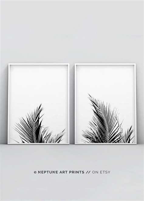 Two Black And White Prints With Palm Leaves