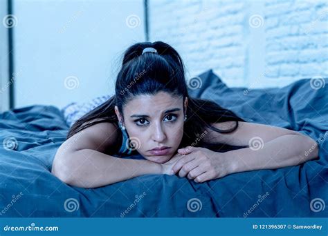 Sad And Depressed Portrait Of Latin Woman On Bed With White Back Stock Image Image Of Hispanic