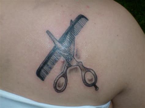 Comb And Scissor In Mirror Tattoo On Shoulder