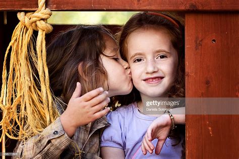 Boy Kissing Girl On The Cheek High Res Stock Photo Getty Images