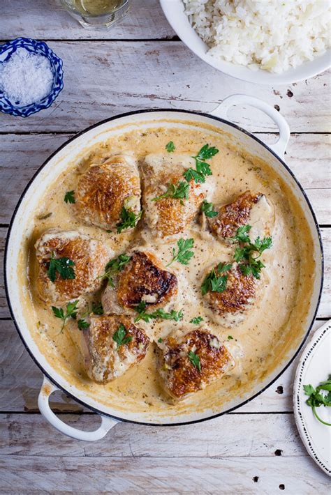 Crispy, golden chicken thighs in a smooth and creamy garlic dijon sauce with crispy bacon pieces and spinach! Nigel Slater's Coq au Riesling - Simply Delicious