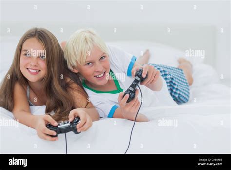 Cheerful Siblings Playing Video Games Stock Photo Alamy